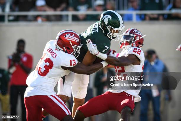 Spartans wide receiver Cody White gets hit hard by a pair of Hoosiers defenders on a punt return during a Big Ten Conference NCAA football game...