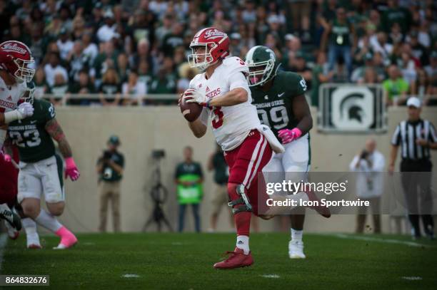 Hoosiers quarterback Peyton Ramsey rolls out of the pocket to pass during a Big Ten Conference NCAA football game between Michigan State and Indiana...