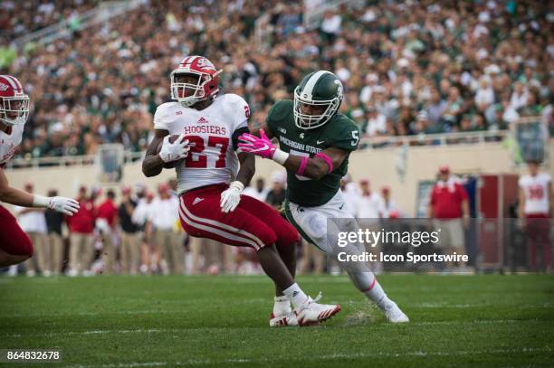 Hoosiers running back Morgan Ellison tries to spin away from the tackle of Spartans linebacker Andrew Dowell during a Big Ten Conference NCAA...