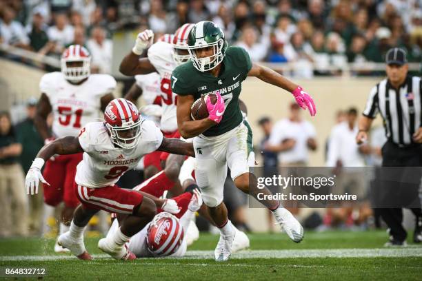 Spartans wide receiver Cody White escapes the tackle of Hoosiers safety Jonathan Crawford during a Big Ten Conference NCAA football game between...