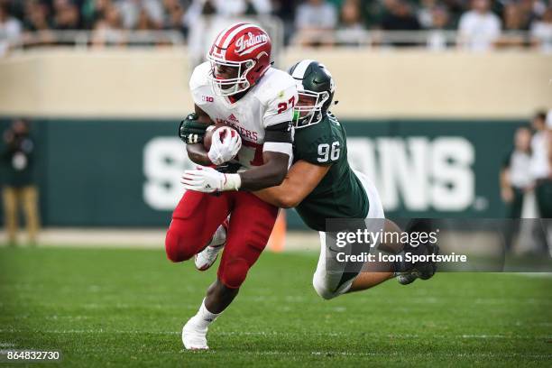Spartans defensive end Jacob Panasiuk dives to bring down Hoosiers running back Morgan Ellison during a Big Ten Conference NCAA football game between...