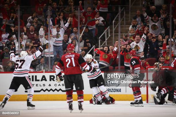 Lance Bouma of the Chicago Blackhawks celebrates with Tommy Wingels after scoring a goal against goaltender Louis Domingue of the Arizona Coyotes...