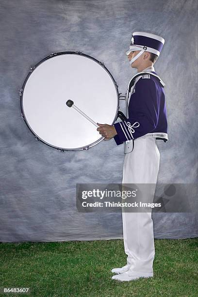 bass drum player in marching band - bass drum stock-fotos und bilder