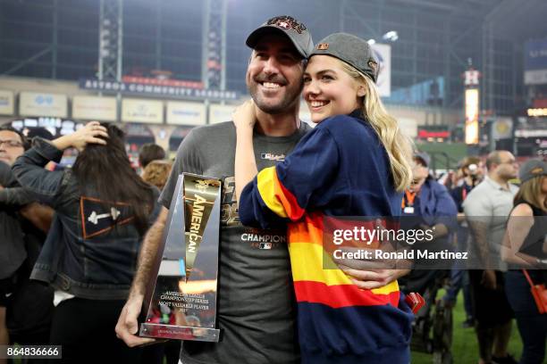 Justin Verlander of the Houston Astros celebrates with model Kate Upton and the MVP trophy after defeating the New York Yankees by a score of 4-0 to...