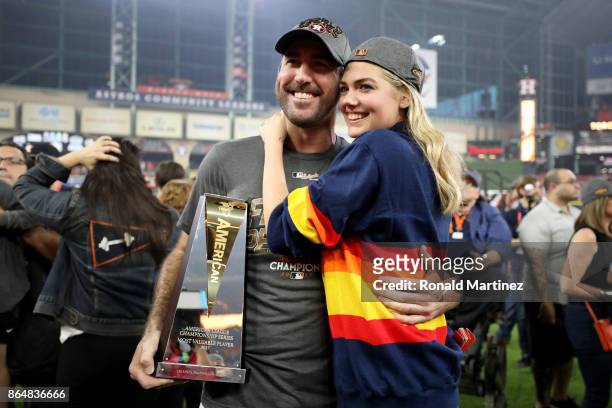 Justin Verlander of the Houston Astros celebrates with model Kate Upton and the MVP trophy after defeating the New York Yankees by a score of 4-0 to...