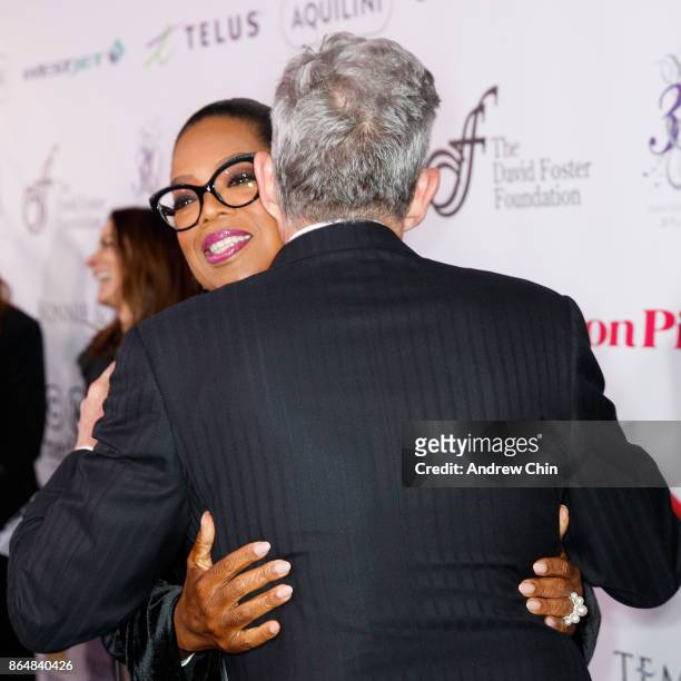 David Foster greets Oprah Winfrey during the David Foster Foundation Gala at Rogers Arena on October 21, 2017 in Vancouver, Canada.