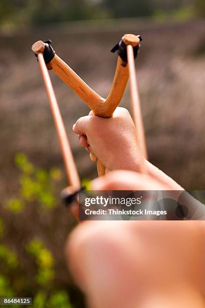 hands holding sling shot - catapult stock pictures, royalty-free photos & images