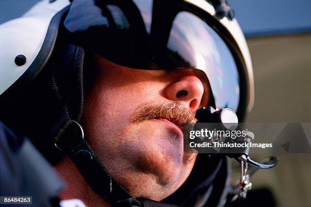 helicopter pilot wearing helmet and headset - helicopter pilot stock pictures, royalty-free photos & images