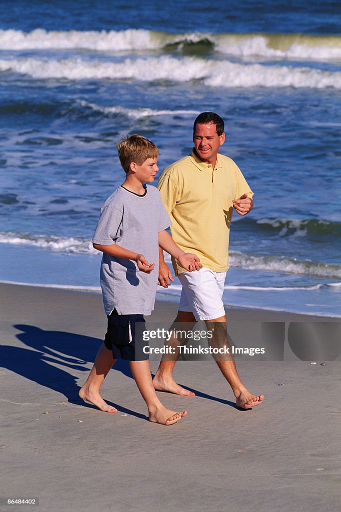 Father and son walking on beach