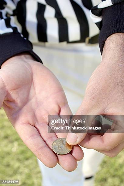 referees hands with coin - münzwurf stock-fotos und bilder