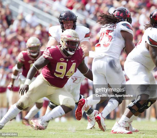 Florida State Seminoles defensive tackle Walvenski Aime looks to tackle Louisville Cardinals running back Dae Williams during the game between the...