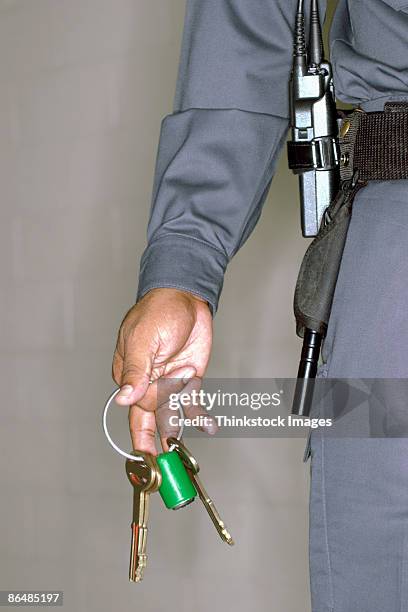 hand of corrections officer with keys - warders stock pictures, royalty-free photos & images