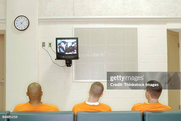 inmates watching television - prison uniform stock pictures, royalty-free photos & images