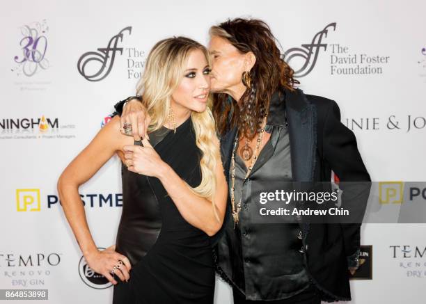 Steven Tyler kisses Aimee Preston during the David Foster Foundation Gala at Rogers Arena on October 21, 2017 in Vancouver, Canada.