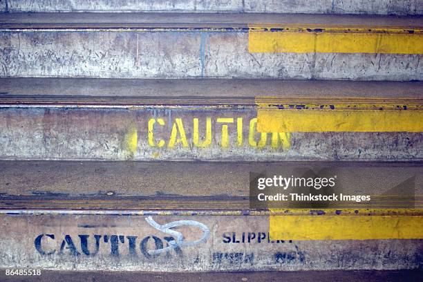 steps with caution painted on them - varning för halka bildbanksfoton och bilder