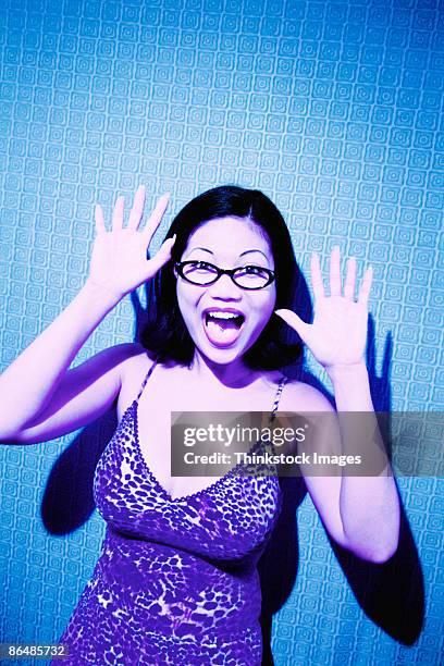 woman startled with arms raised - tongue stud stock pictures, royalty-free photos & images