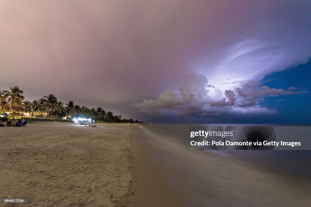 Amazing lightning storm sunset and calmed ocean, at Naples beach, Florida, USA