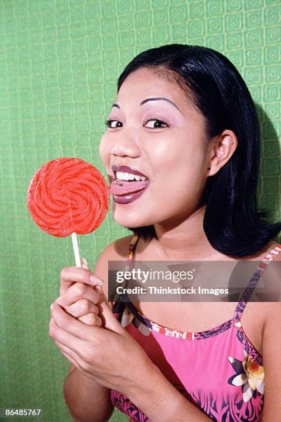woman licking lollipop - tongue stud stock pictures, royalty-free photos & images