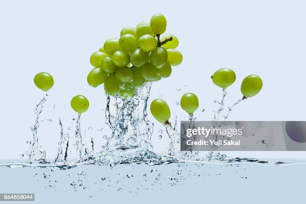 strawberrys jump out  on line except one  from water - green grape stock pictures, royalty-free photos & images