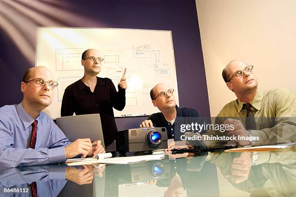 businesspeople with same head watching presentation - cloning device stock pictures, royalty-free photos & images