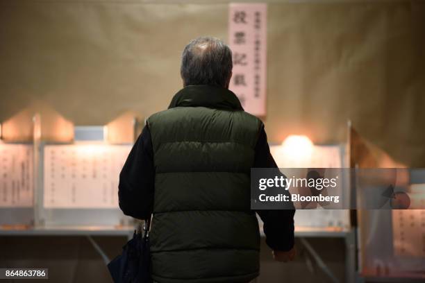 Voter walks towards a voting booth at a polling station during a general election in Tokyo, Japan, on Sunday, Oct. 22, 2017. More than 100 million...