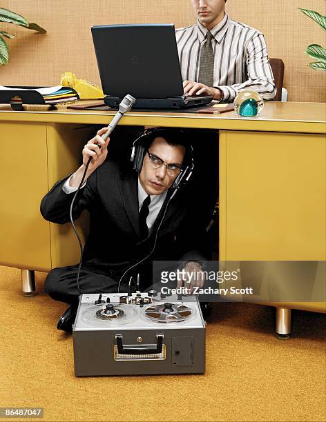 spy recording a man typing at desk  - eavesdropping stock pictures, royalty-free photos & images