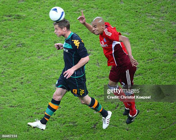 Markus Rosenberg of Werder Bremen and Alex Silva of Hamburg go up for a header during the UEFA Cup Semi Final second leg match between Hamburger SV...