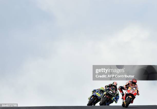 Honda rider Marc Marquez of Spain leads a pack during the Australian MotoGP Grand Prix at Phillip Island on October 22, 2017. / AFP PHOTO / PAUL...