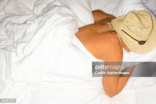 woman wearing cowboy hat in bed - cowboy sleeping stock pictures, royalty-free photos & images