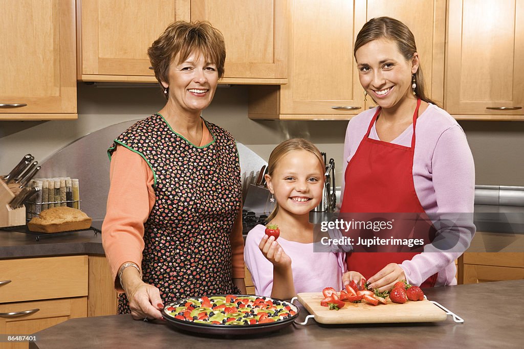 Generations of women cooking together in kitchen