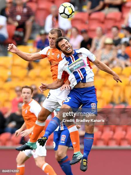 Luke DeVere of the Roar and Benjamin Kantarovski of the Jets challenge for the ball during the round three A-League match between the Brisbane...