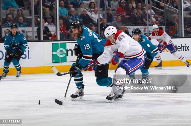 Joe Thornton of the San Jose Sharks skates after the puck against Ales Hemsky of the Montreal Canadiens at SAP Center on October 17, 2017 in San...