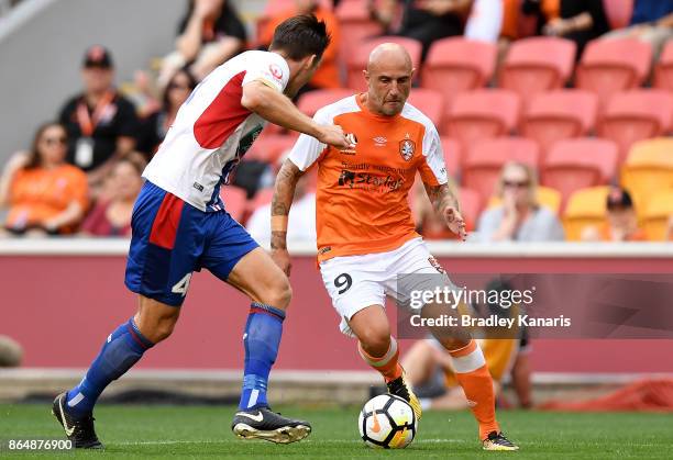 Massimo Maccarone of the Roar takes on the defence during the round three A-League match between the Brisbane Bullets and the Newcastle Jets at...