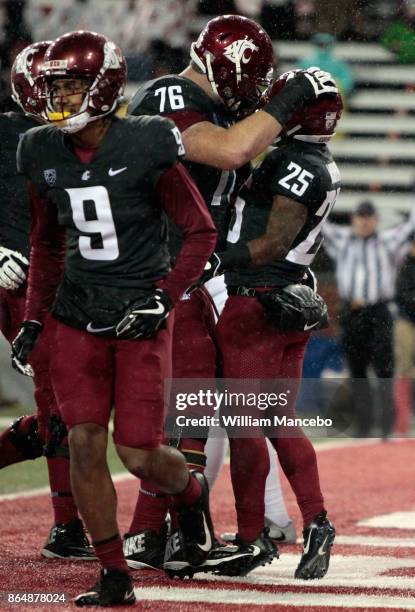 Jamal Morrow of the Washington State Cougars celebrates his touchdown against the Colorado Buffaloes with teammate Cody O'Connell in the second half...