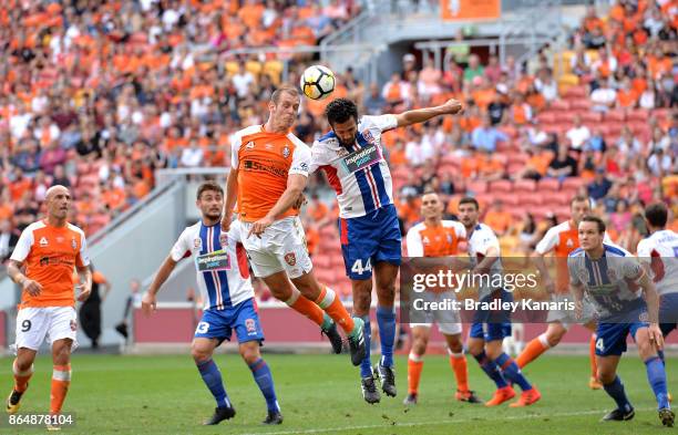 Luke DeVere of the Roar and Nikolai Topor-Stanley of the Jets challenge for the ball during the round three A-League match between the Brisbane...