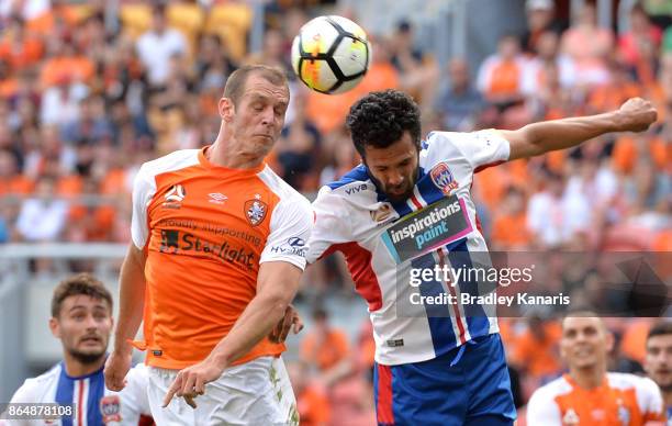 Luke DeVere of the Roar and Nikolai Topor-Stanley of the Jets challenge for the ball during the round three A-League match between the Brisbane...