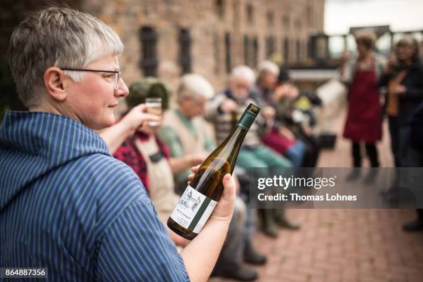 Nun Thekla of St. Hildegard Abbey offers volunteers a glas wine during lunch break after harvesting grapes for their annual vintage on October 04,...