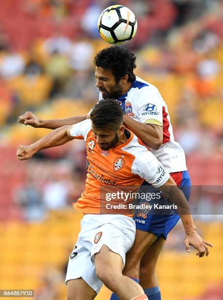 Petros Skapetis of the Roar and Nikolai Topor-Stanley of the Jets challenge for the ball during the round three A-League match between the Brisbane...