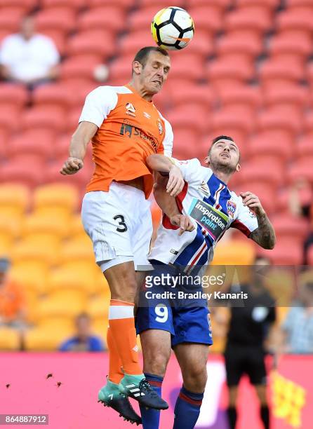 Luke DeVere of the Roar gets above Rory O'Donovan of the Jets during the round three A-League match between the Brisbane Bullets and the Newcastle...
