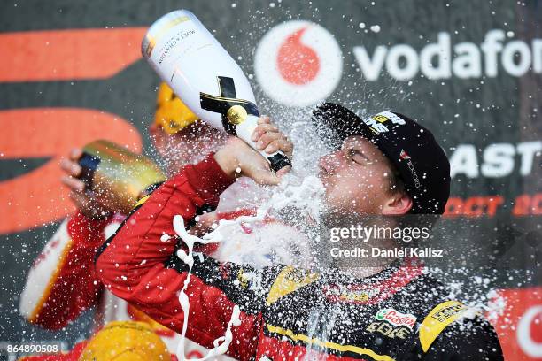 Chaz Mostert driver of the Supercheap Auto Racing Ford Falcon FGX celebrates on the podium after race 22 for the Gold Coast 600, which is part of the...
