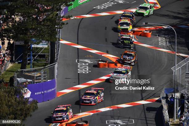 Jamie Whincup drives the Red Bull Holden Racing Team Holden Commodore VF leads the field on lap one during race 22 for the Gold Coast 600, which is...