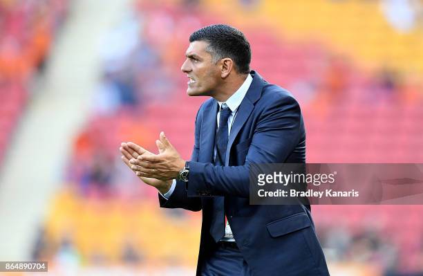 Coach John Aloisi of the Roar encourages his players during the round three A-League match between the Brisbane Bullets and the Newcastle Jets at...
