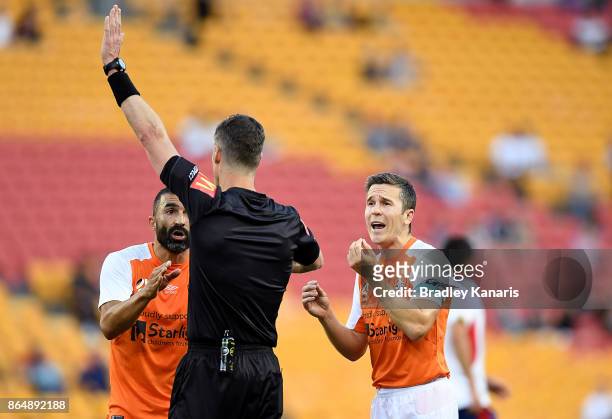 Matthew McKay of the Roar argues the point with referee Matthew Conger after a goal was taken from the Roar during the round three A-League match...