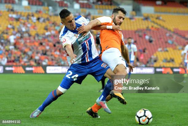 Petros Skapetis of the Roar and Joseph Champness of the Jets challenge for the ball during the round three A-League match between the Brisbane...