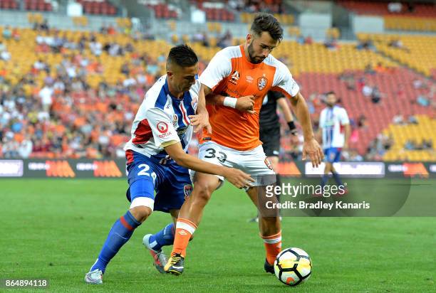 Petros Skapetis of the Roar and Joseph Champness of the Jets challenge for the ball during the round three A-League match between the Brisbane...