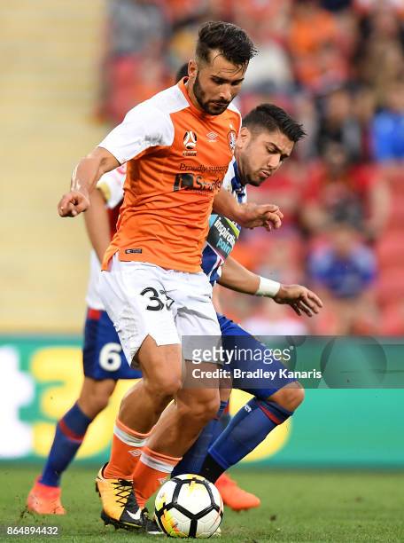 Petros Skapetis of the Roar and Dimitri Petratos of the Jets compete for the ball during the round three A-League match between the Brisbane Bullets...