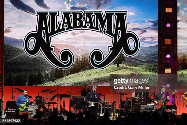 Jeff Cook, Randy Owen and Teddy Gentry of Alabama perform in concert during the "Deep From The Heart: One America Appeal Concert" at Reed Arena on...