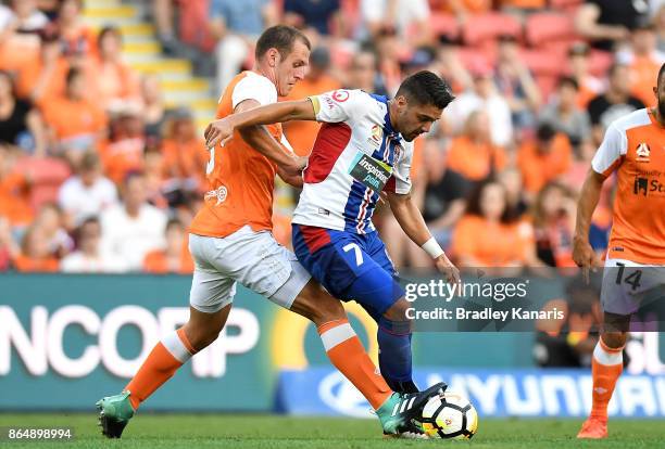 Dimitri Petratos of the Jets is challenged by Luke DeVere of the Roar during the round three A-League match between the Brisbane Bullets and the...