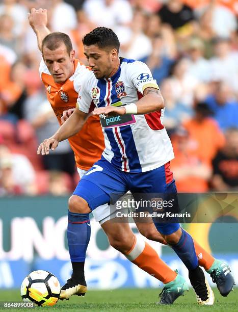 Dimitri Petratos of the Jets is challenged by Luke DeVere of the Roar during the round three A-League match between the Brisbane Bullets and the...