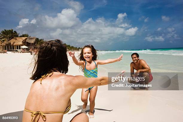 family playing at the beach - playa del carmen photos et images de collection